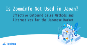 Banner header: 'Is ZoomInfo Not Used in Japan?' with subtitle about outbound sales in Japan; illustration of people around a large computer with charts; Techro logo in bottom-left.